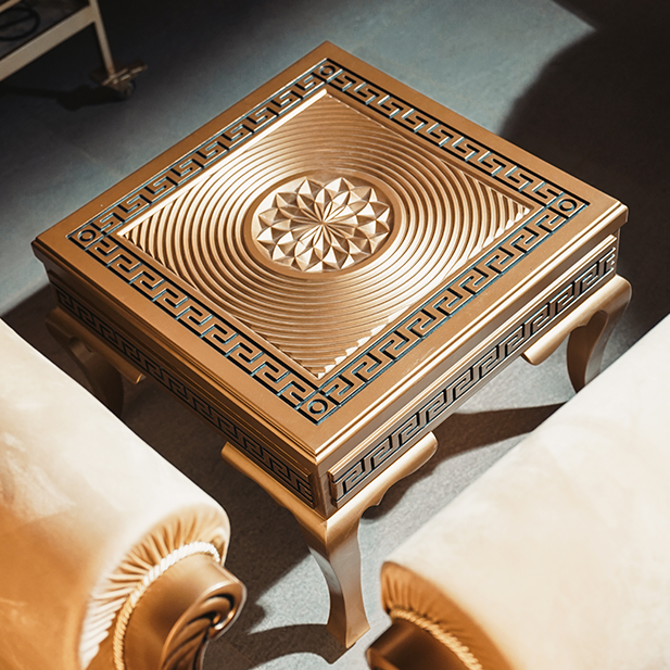 Close view of the patterned tabletop and carved detailing of a PFI centre table